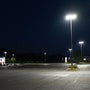 LED Shoebox Area Light 150W illuminating a large outdoor parking area at night with bright, even lighting.