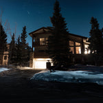 Night view of a home illuminated by a powerful and efficient 200W Ecobright LED Flood Light outdoors