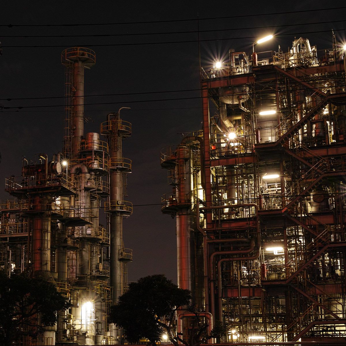 Industrial facility illuminated at night using LED Hazardous Location Marine Grade Flood Light 150W MaxLite HL-AR