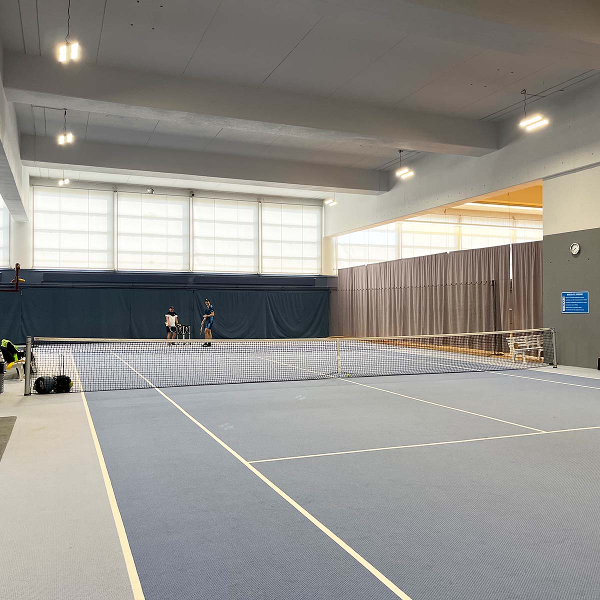Indoor sports arena illuminated by Linear LED High Bay with swappable optics and durable IP66 IK10 rating