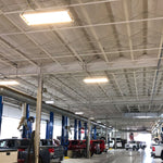 Linear LED High Bay 120W 17400 lm lights illuminate a spacious commercial workshop with high ceilings and vehicles.