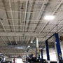 480W LED Linear High Bay Panel lighting a large industrial garage with bright white light from the ceiling fixtures