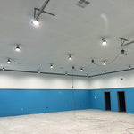 Large commercial space illuminated by multiple 90W High Lumen Dimmable LED Low Bay Fixtures with bright white light