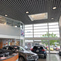 Modern commercial interior with LED High Bay Retrofit Lamp E39 150W illuminating a car showroom space