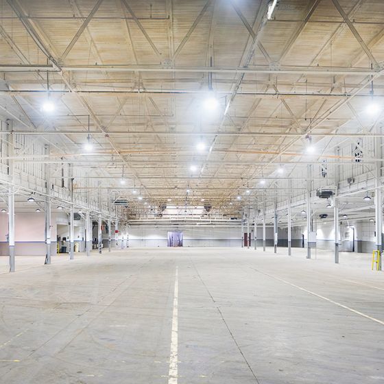 Brightly lit large industrial warehouse using 200W Ultra-High Lumen Dimmable High Bay LED Lights overhead